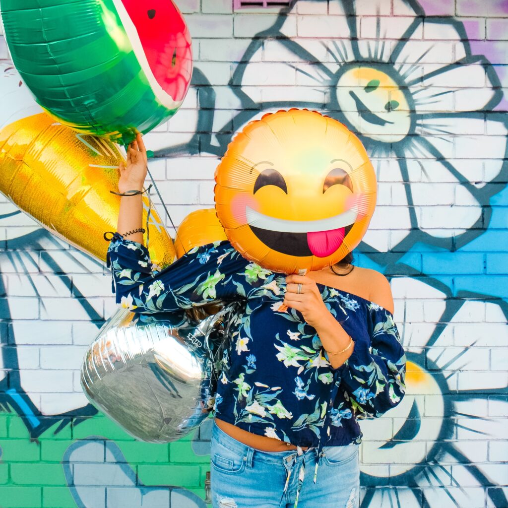 girl with emoji baloon
