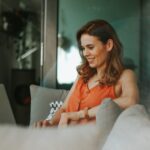 a business woman in the couch using laptop